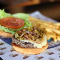 Rurik Tampiquena Burger · Caramelized hatch green chile, onions and Jack cheese on top of a burger patty, with refried...