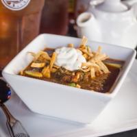 Tortilla Soup · A delicious broth made with a variety of chilies and onions. The soup comes with chicken, av...