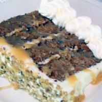 Towering Carrot Cake · Four layers of moist cake, filled with carrots, pecans and pineapples. Iced and layered with...