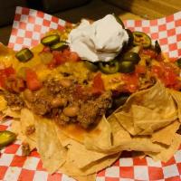 Red Douglas Supreme Nachos · Our red chili added over fresh tortilla chips, topped with cheddar cheese, jalapenos, tomato...