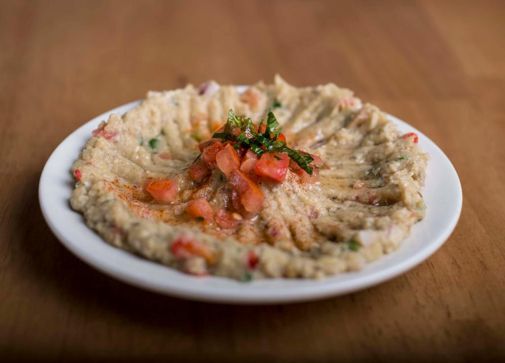 Eggplant Salad · Char-grilled eggplant puree with garlic, onion, roasted red pepper, herbs, tomatoes and parsley.