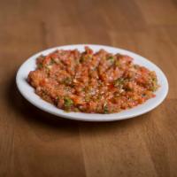Spicy Ezme · Tomato, onion and pepper chopped finely and seasoned with our special dressing. Hot.