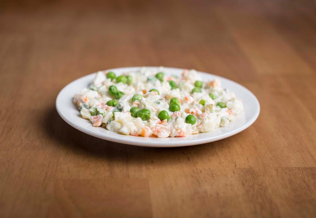 Russian Salad · Boiled potatoes, eggs, carrots, pickles and green peas mixed with mayonnaise.