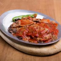 Iskender · Lamb gyro in a lightly hot tomato sauce over fried pita bread served with hot butter sauce a...