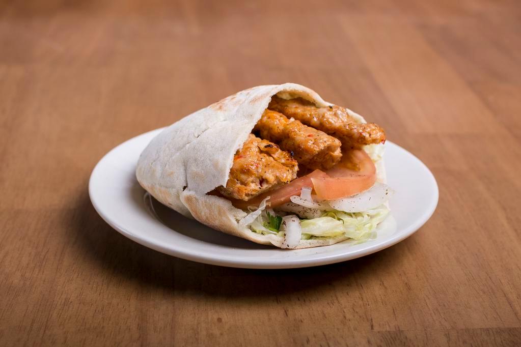 Chicken Adana Sandwich · Includes lettuce, tomato, onions and sauce.