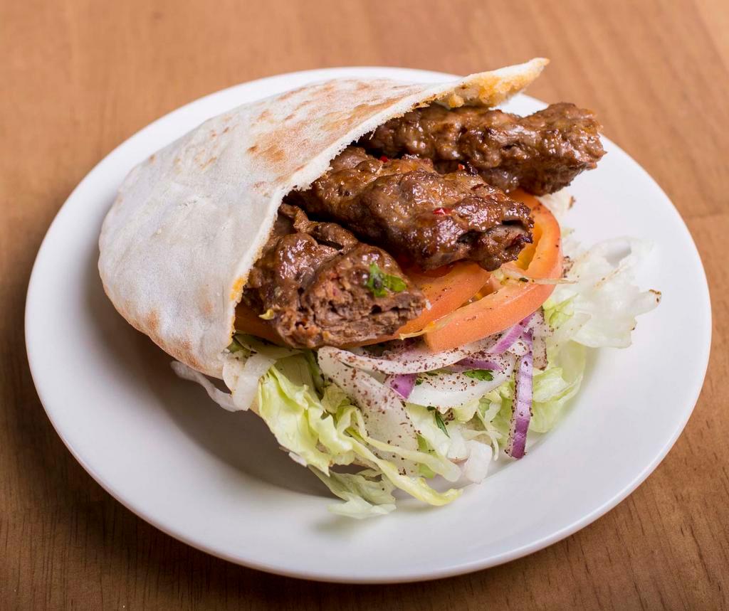 Adana Kebab Sandwich · Includes lettuce, tomato, onions and sauce.