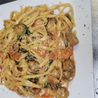 Fettuccine ala Vodka · With fresh basil, fresh garlic, sauteed in olive oil, fresh mushrooms and tomatoes in a pink...