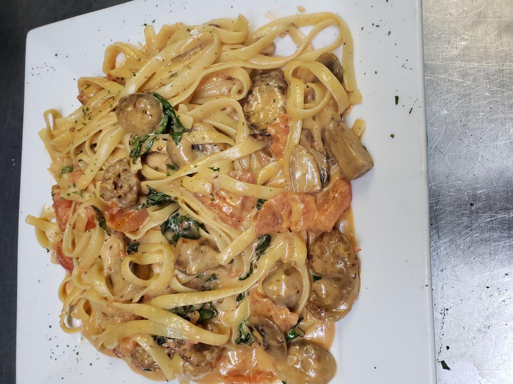 Fettuccine ala Vodka · With fresh basil, fresh garlic, sauteed in olive oil, fresh mushrooms and tomatoes in a pink vodka creamy sauce. Includes garlic bread and Small Garden salad.