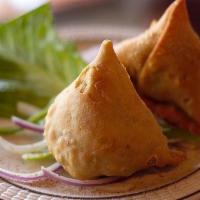 Vegetable Samosa · Savory deep fried pastry puffs filled with mildly spiced potato and peas.