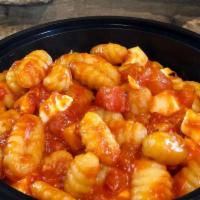 Gnocchi al Telefono · Potato dumplings with roasted garlic, basil, fresh tomato sauce and fresh mozzarella cheese.