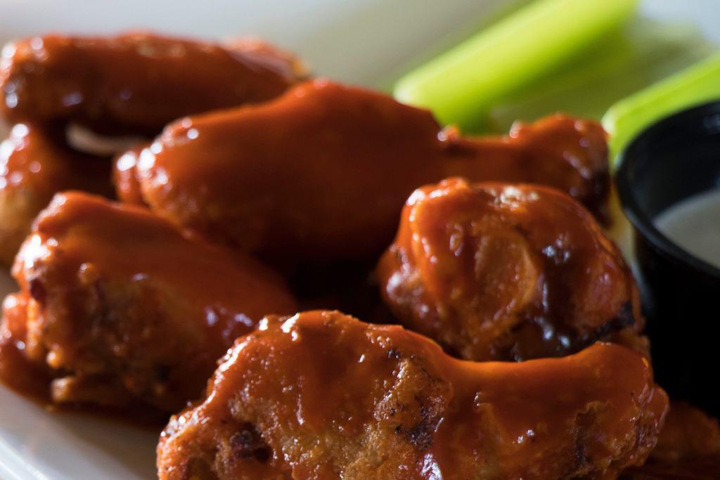Chicken Wings · Tender bone-in chicken wings smothered in Choice of Rich Sauce, served with Celery and choice of ranch or blue cheese dressing. 
