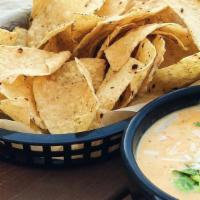 Queso and Chips · Our signature melted cheese dip with Crispy Tortilla Chips.