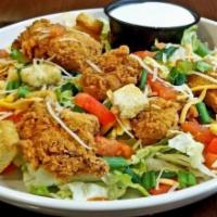 Crispy Chicken Tenders Salad · Mixed greens topped with crispy chicken strips, hard-boiled eggs, pecan wood-smoked bacon cr...