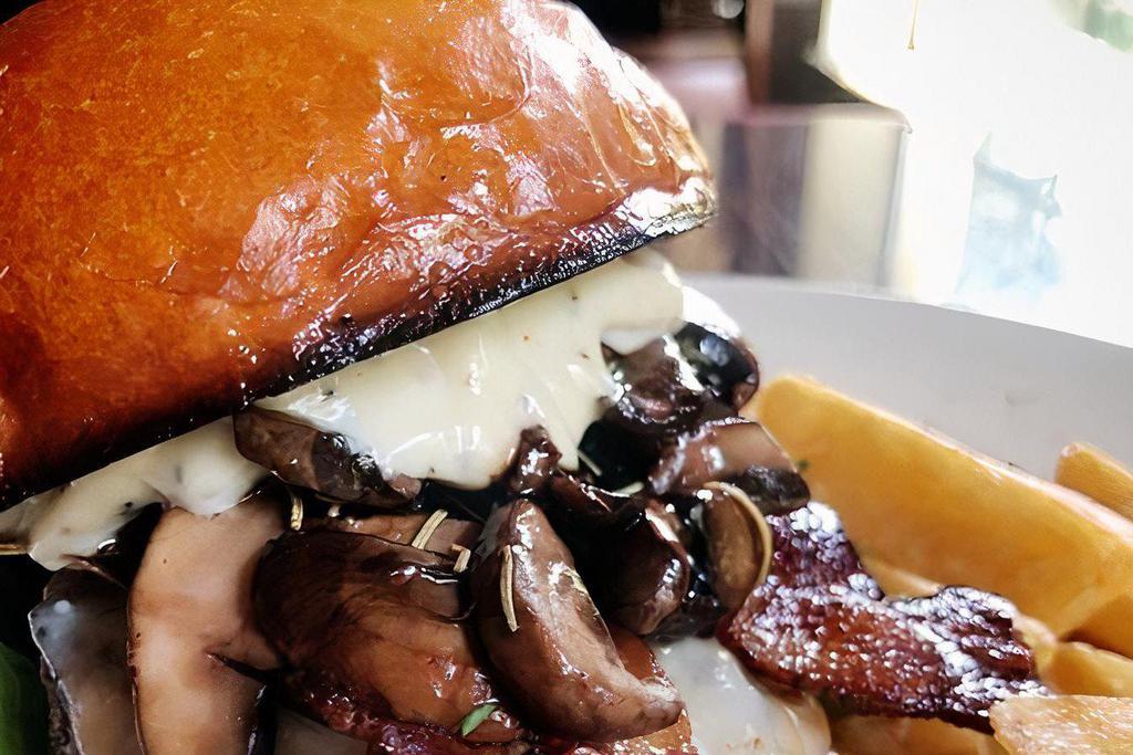 Mushroom Swiss Burger · Topped with sautéed mushrooms, grilled onions, Swiss cheese and garlic spread.