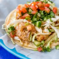 Shrimp Taco · Grilled seasoned shrimp on corn tortillas topped with cabbage, cucumber, cilantro, salsa fre...