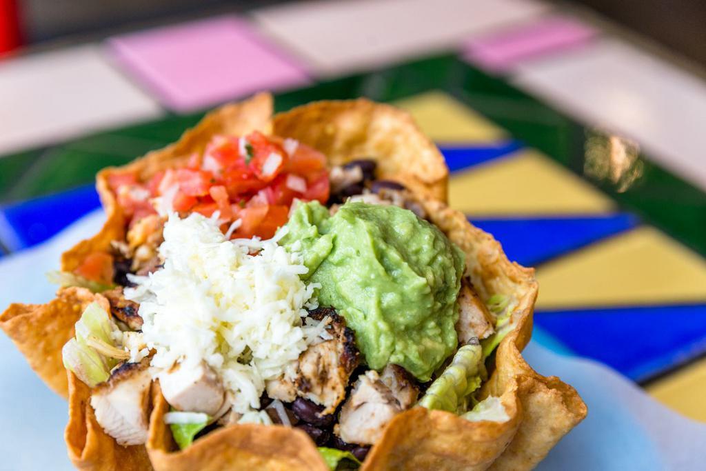 Tostada Salad · Romaine lettuce, black beans, Jack cheese, salsa fresca and guacamole served in a flour tortilla shell.