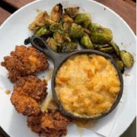 Rosemary Hot Honey Dipped Crispy Chicken · boneless thighs, hot honey macaroni + cheese, roasted brussel sprouts