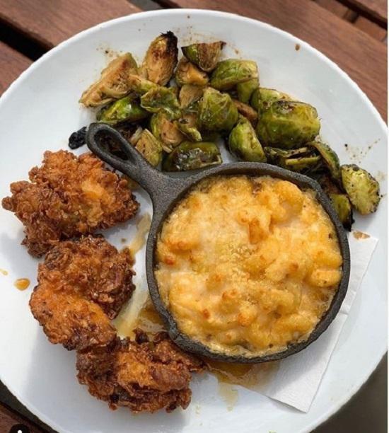 Rosemary Hot Honey Dipped Crispy Chicken · boneless thighs, hot honey macaroni + cheese, roasted brussel sprouts