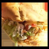 Ground Beef Torta · Served with beans, sour cream, lettuce, pico de gallo, and cheese.