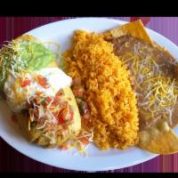 Chimichanga Combo · Deep fry burrito with your choice of meat with rice, beans and cheese inside and topped with...