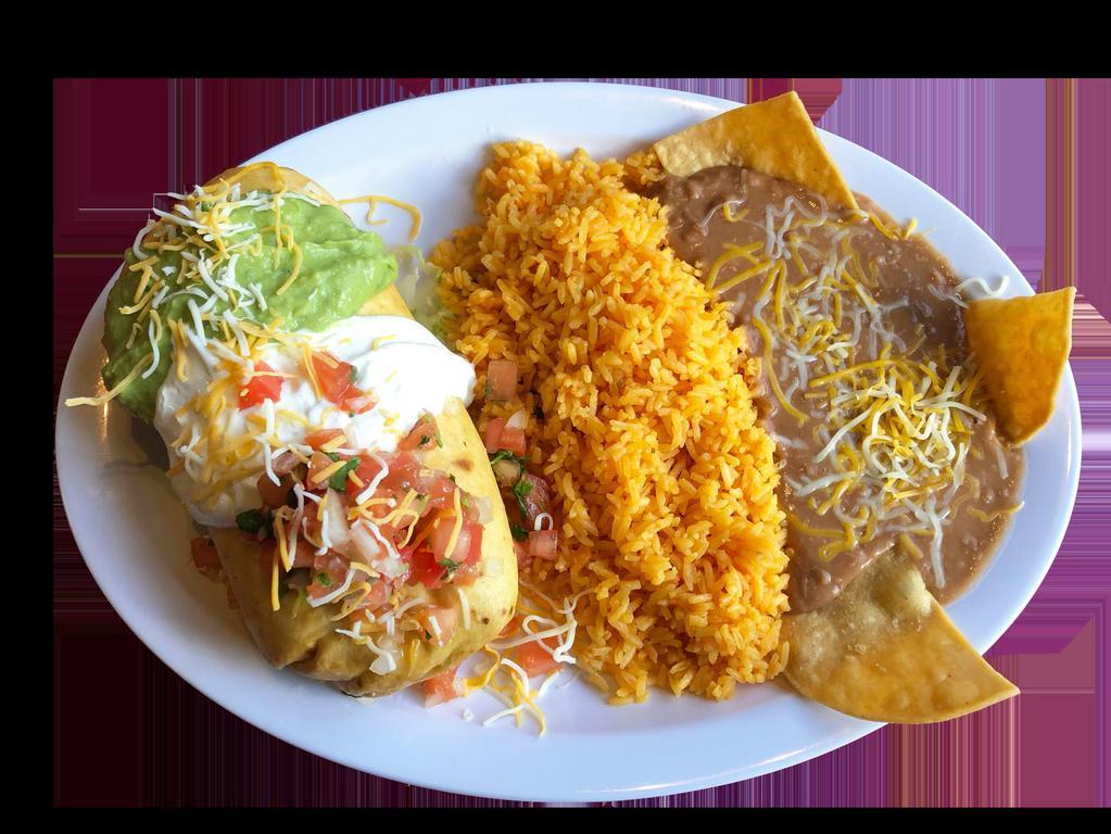 Chimichanga Combo · Deep fry burrito with your choice of meat with rice, beans and cheese inside and topped with pico de gallo, sour cream, guacamole and cheese, serve with rice, refried beans garnished with cheese and tortilla chips