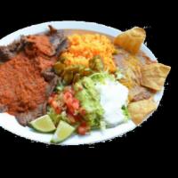 Ranchero Plate · flat grill steak topped with ranchero sauce, served with rice, refried beans garnished with ...