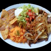 Bistec Encebollado · 
8oz of flat grill steak topped with sautéed onions, served with rice, refried beans garnish...