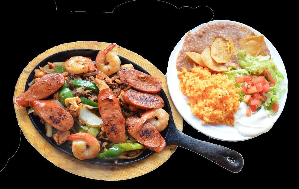 Fajita Mix · Grilled chicken, steak, chopped onions and peppers, Chorizo and sautéed jumbo shrimp. Serve with rice, refried beans garnished with cheese and tortilla chips, lettuce, guacamole, sour cream, pico de gallo, jalapeño peppers, lime wedges and tortillas on the side