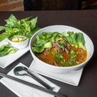 Spicy Noodle Soup · Bun bo hue. Round rice noodles with sliced brisket and steamed Vietnamese pork in special sp...
