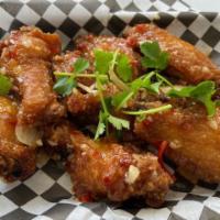 A2. Honey Garlic Wings · Canh ga chien gion. Crispy chicken wings tossed with honey garlic sauce.