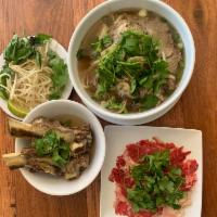 P1. Pho Bistro · Pho dac biet with ribeye steak strip, meat balls, flank, brisket, tendons and tripe in a ric...