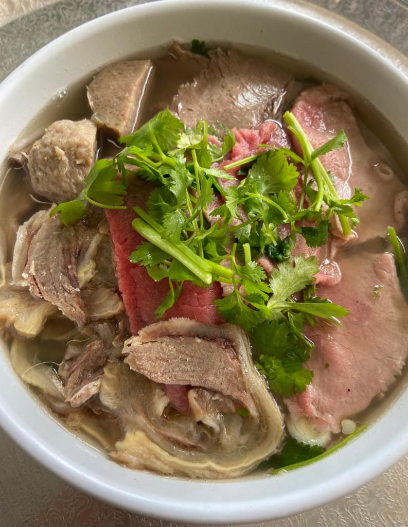 P2. Pho Dac Biet · Sliced eye round beef, meat balls, flank, brisket, tendons and tripe in a rich beef broth with rice noodles. Add add-ons for an additional charge.