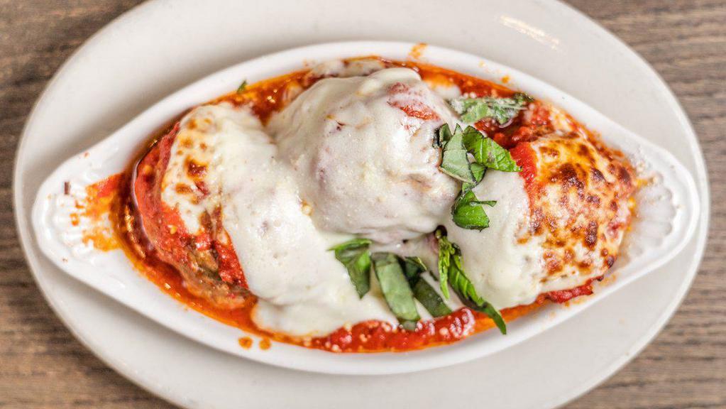 Italian Meatballs · Homemade Italian meatballs oven baked, covered with our red sauce and mozzarella cheese.