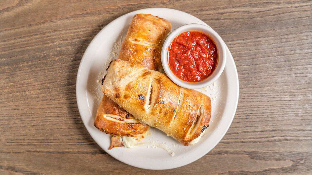 Stromboli · Made to order! Ham, pepperoni, Italian sausage and mozzarella cheese. Served with a side of red sauce. Please allow for extra baking time.