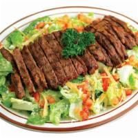 Asada Salad · Grilled steak strips with pepita dressing. Served on a bed of tossed romaine, lettuce with t...