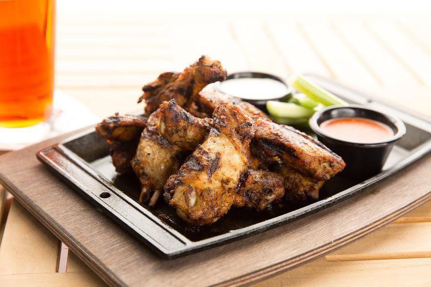 Spicy Grilled Wings · Full pound of spicy marinated grilled wings with buffalo or BBQ sauce served with ranch or blue cheese dressing. Gluten-Free. Spicy Hot.
