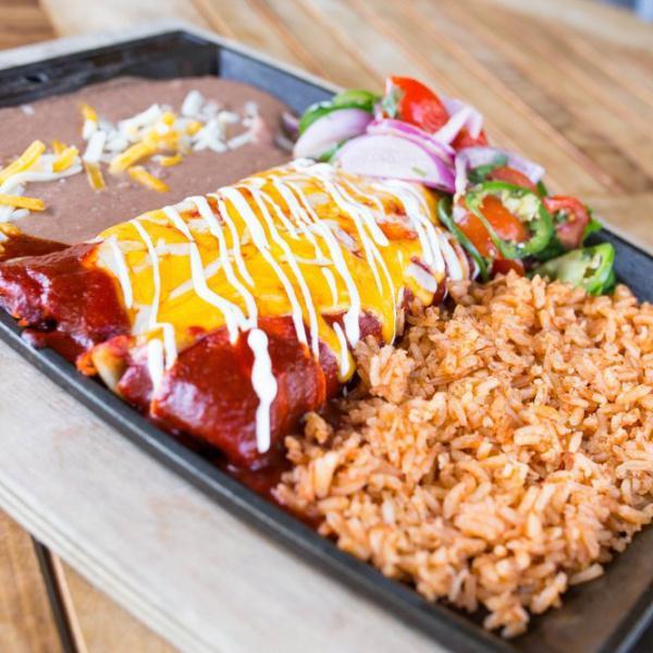 Cheesy Enchiladas · Monterey and cheddar cheese wrapped up in 3 thick corn tortillas, smothered in red or green enchilada sauce and sour cream. Served with Mexican rice and refried beans.