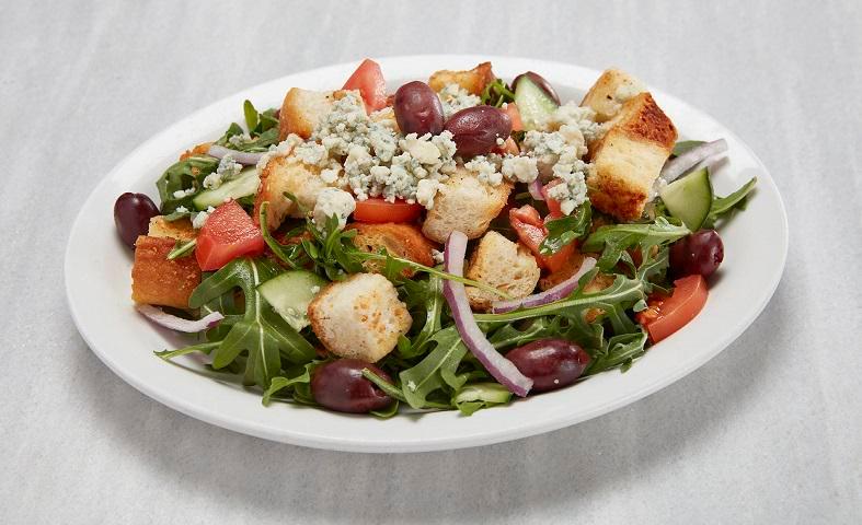 Panzanella Salad · This rustic Tuscan chopped salad uses plenty of coal-fired croutons, tomatoes, cucumbers and red onions tossed with our tangy house dressing, served over arugula with Gorgonzola cheese and Kalamata olives.