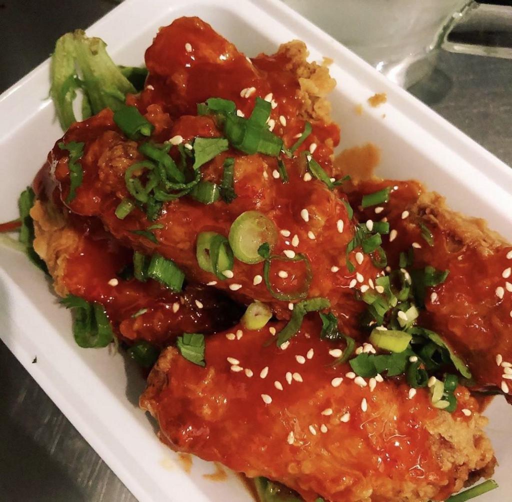 Sriracha Chicken Wings · Marinated fried chicken tossed with Sriracha hot sauce. Hot and spicy.