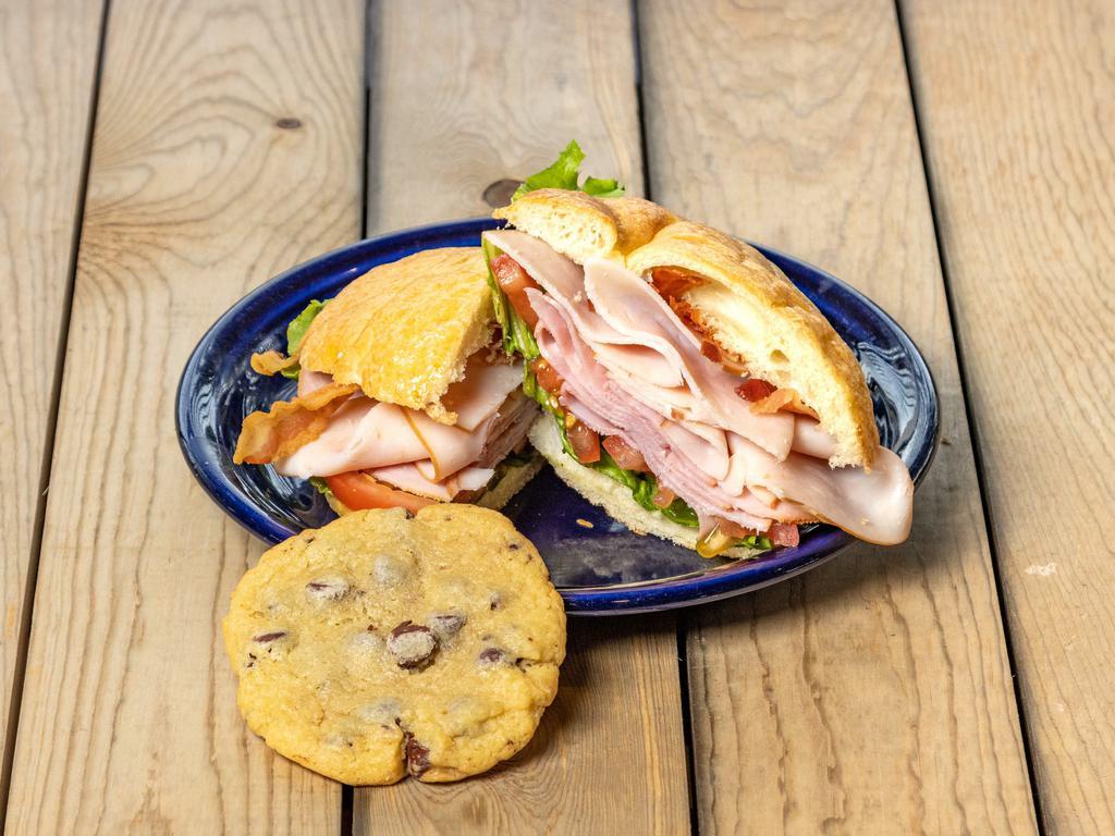 Full Paradise Club Sandwich · Oven roasted turkey breast, ham, smoked bacon with creamy Dijon mayo vinaigrette on our buttery, flaky croissant. Served with lettuce and tomato.