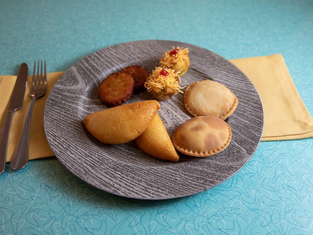 Sampler Plate · A combination of 2 arepa pop, 2 mini patacon, 2 pastelitos and 2 empanadas.