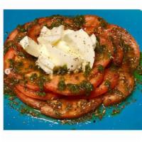 Caprese Salad · Italian salad, made of sliced fresh mozzarella, tomatoes and basil dressing, seasoned with s...