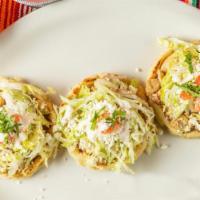Sopes de Pollo · 3 pieces. Served with lettuce, cheese, and cream.
