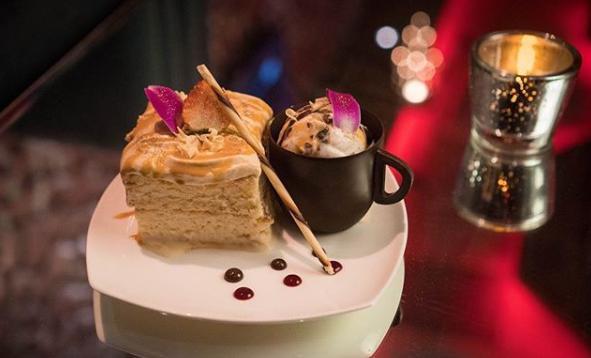 Tres Leche Dessert Duo · Chef’s special slice of dulce de leche 3 milk cake topped with caramel whipped cream, brown sugar sauce paired with a scoop or caramel pretzel ice cream in an edible chocolate cup