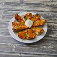 Potato Skins · Baked Idaho potato skins served with melted cheddar cheese and bacon bits.