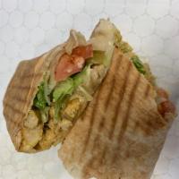 Chicken Kebab Sandwich · Wrapped with lettuce, tomatoes, pickles, garlic sauce and tahini. Served wrapped in pita bre...