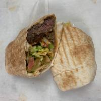 Kofta Kebab Sandwich · Wrapped with lettuce, tomatoes, pickles, tahini and hummus. Served wrapped in pita bread.