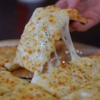 Cheese Sticks · Brushed with butter oil, mozzarella cheese, seasoned with our Israeli spice and baked to gol...