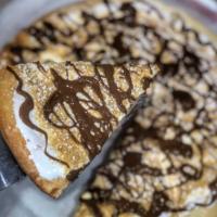 S'mores Pie · Sweet dough baked with marshmallow fluff and topped with graham cracker crumbs and a drizzle...