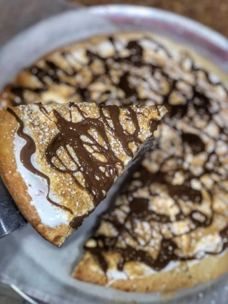 S'mores Pie · Sweet dough baked with marshmallow fluff and topped with graham cracker crumbs and a drizzle of Swiss milk chocolate.